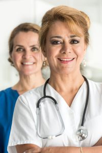 Mature Female doctors posing smiling looking at the camera