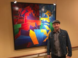 William Butler in front of painting at The Samaritan Center Vorhees 