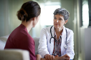 Hospice physician speaking to a caregive