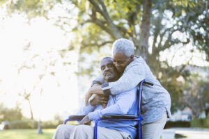 senior African American couple outdoors hugging