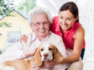 elderly mom and daughter with pet dog