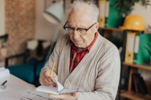 elderly man reading diary