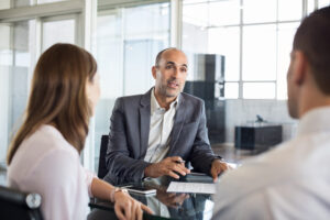 financial agent talking to young couple 