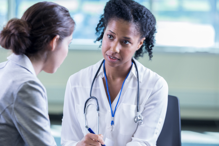 Physician listens to patient