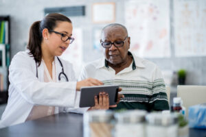 doctor reviewing patient data with african american man
