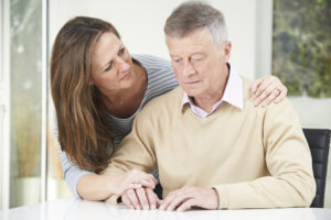 Adult daughter comforting older father