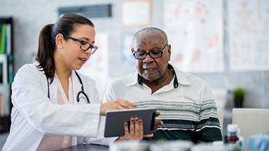 Young doctor talking to senior patient