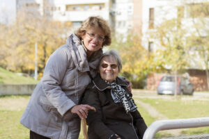 senior daughter smiling with elder mother 