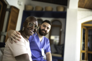 Smiling home caregiver and senior woman