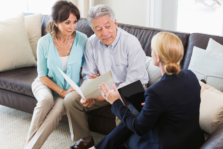 Senior couple talking with advisor