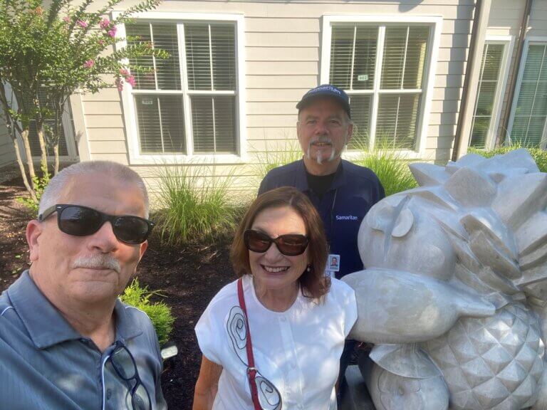 Susi Levy, Jim Ramsey, and Chris Rollins with Bowl of fruit art piece at Samaritan Center Voorhees