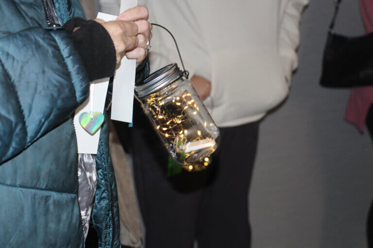 People holding lights at tree