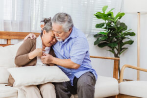 A man comforting a grieving, crying woman) 