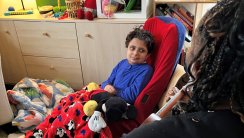 Luke DeFilippo watching Music Therapist Charity Jones