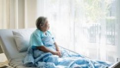 Patient sitting up in bed looking out the window