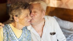 Senior Couple Sharing a Kiss at Home