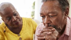 Senior Woman Comforting Man With Depression At Home