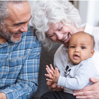 grandma and grandpa hugging grandchild