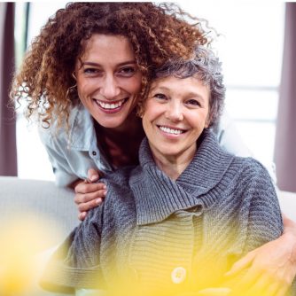 happy woman cuddling mother