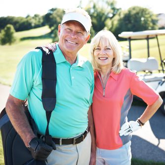 husband and wife golfing