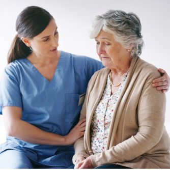 hospice nurse comforting elderly woman