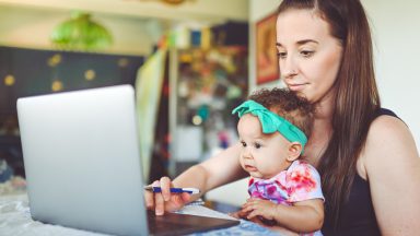 Young girl and infant video chatting