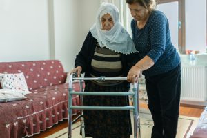 Woman assisting with walker