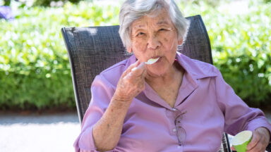 Senior Asian Woman Eating Ice Cream