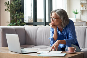 Senior mature older woman working on laptop