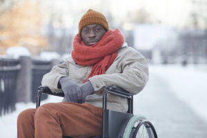 Man in wheelchair outside during winter