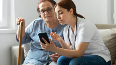 Senior woman with nurse at home