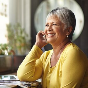 Shot of a mature woman talking on a mobile phone in a coffee shop