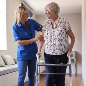 Nurse helping woman walking with aid. 