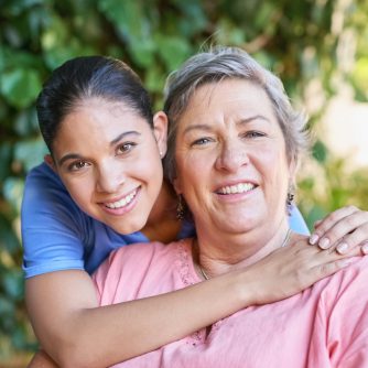 elderly woman in hospice being hugged by daughter