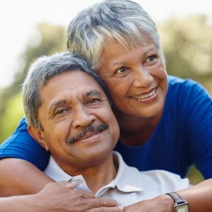 elderly couple embracing